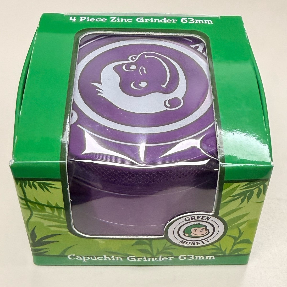 Green Monkey Capuchin 63mm 4-piece grinder in purple, in its retail box